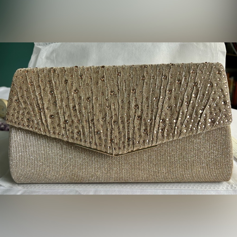 Large Champagne evening bag with detachable chain strap. It is 9 1/2”L x 5 1/2”W